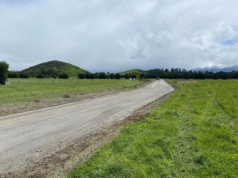 Finished rural access road through open paddocks